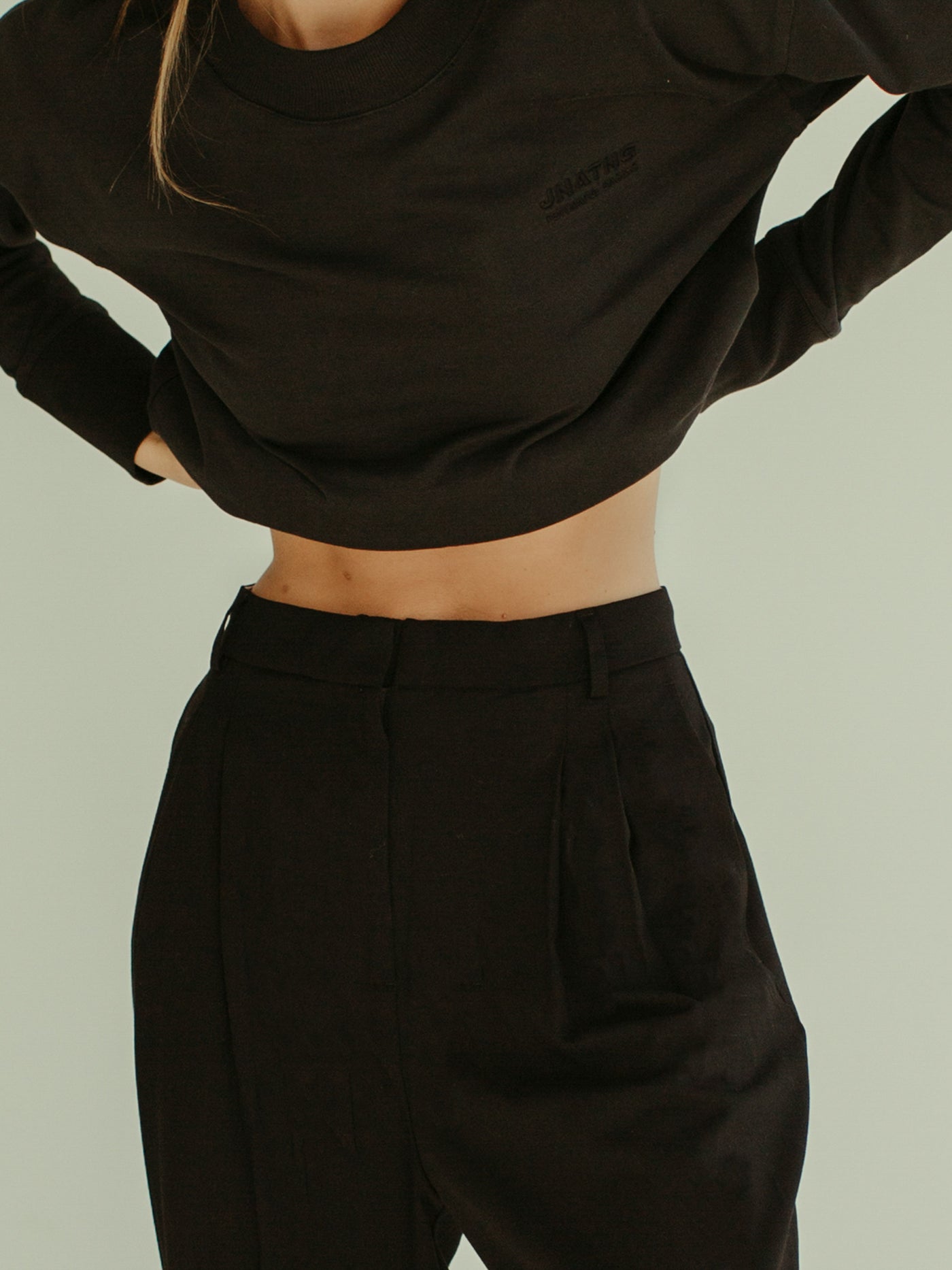 black minimal crewneck sweatshirt and pleated trouser