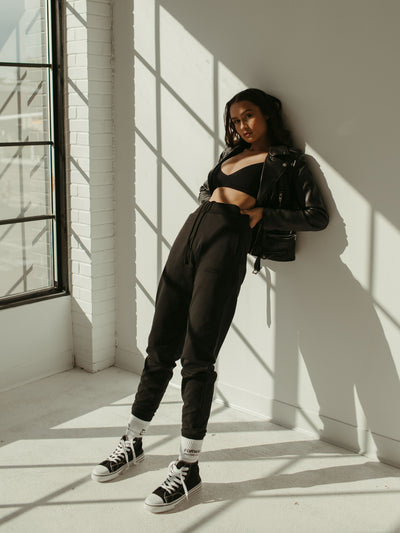 black jogger sweat pant with bralette and leather jacket