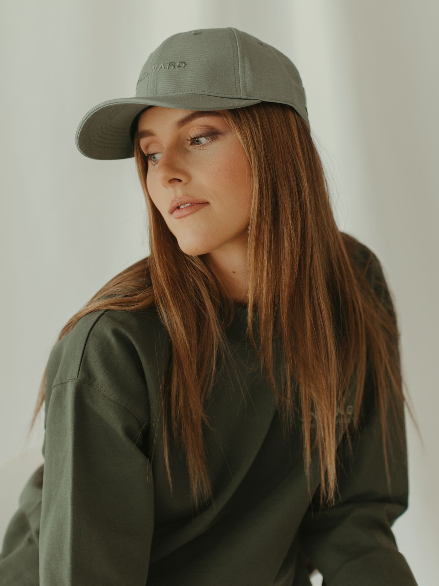 monochrome sage ball cap and crewneck sweatshirt