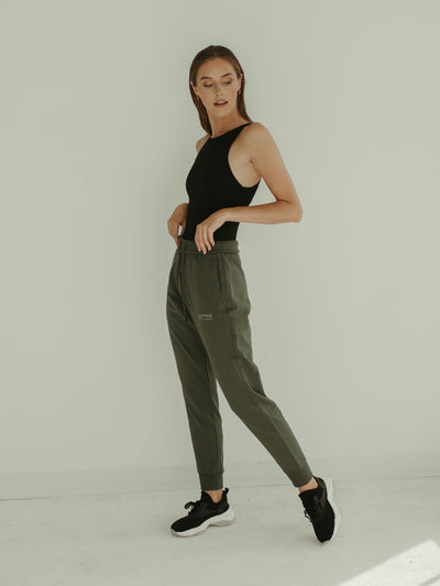 sage green jogger sweatpant and black bodysuit 