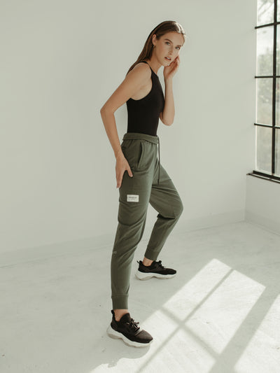 sage green jogger sweat pant and black bodysuit 