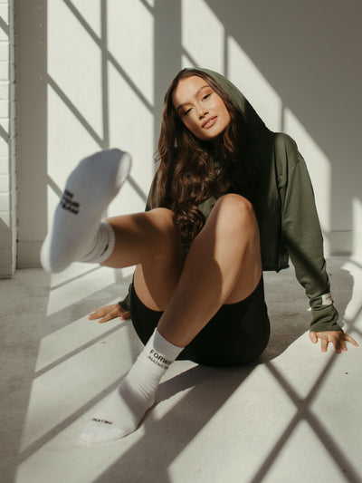 white crew socks with woven logo and cropped sage green hoodie