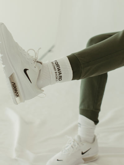 white crew socks with woven logo and sage green jogger